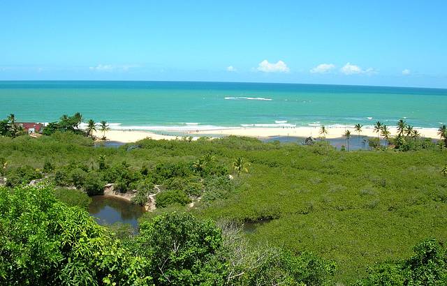 As guas e a grande extenso de areia fina e dourada